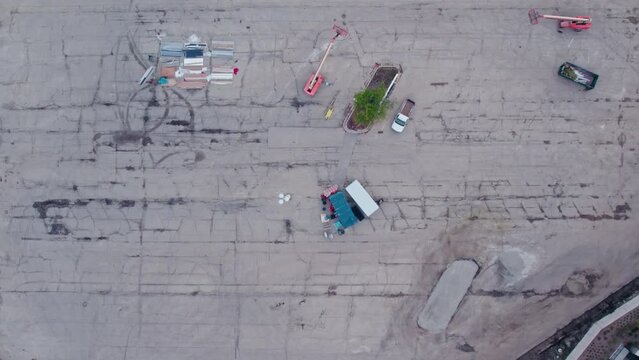 construction equipment on a huge parking lot. Top down aerial