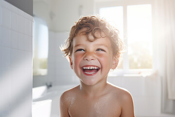 Smiling boy taking a shower in a white bathroom - obrazy, fototapety, plakaty