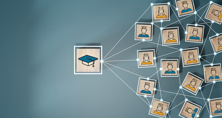 Male and female student icons on wooden blocks. Education concept for success.