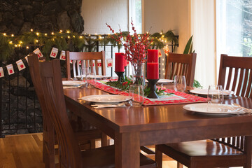 A festive tablescape decorated with candles for Christmas.