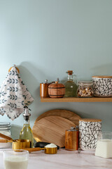 Wooden shelf with rustic cutting board, tea jar and decor in mod