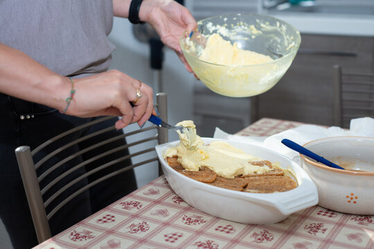 woman's hands prepares tiramisu. Typical Italian dessert