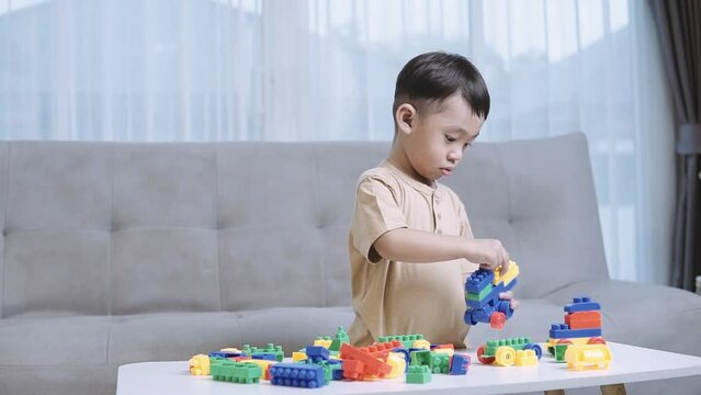 child Playing and learning with building blocks,Child playing with colorful toy blocks. Little boy building tower at home or day care,Educational toys for young children.