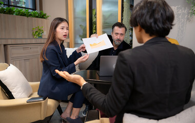 Businessman and businesswoman discussing a project in the meeting room of co-working space