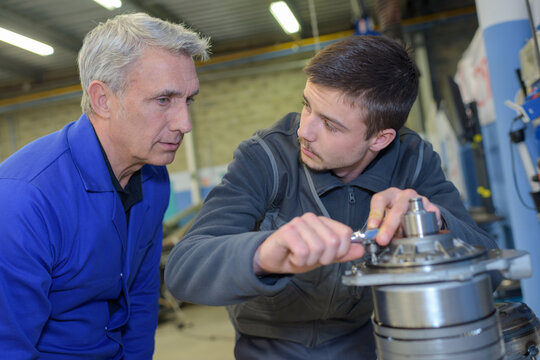 mechanic teaching an intern the best practice