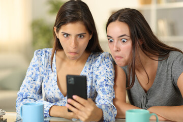 Perplexed women cheking cell phone at home