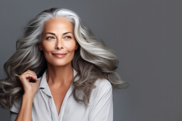 Beautiful aging mature dark woman with long gray hair and happy smiling - obrazy, fototapety, plakaty
