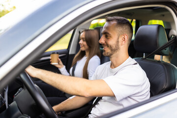 leisure, road trip, travel, family and people concept. happy man and woman driving in car