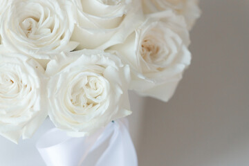 White roses bouquet on white background with soft focus.
