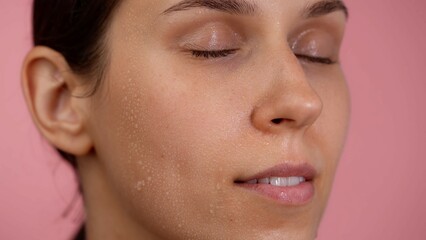 Fototapeta premium Closeup shot of young beautiful caucasian girl face with closed eyes, natural soft skin and no makeup, smiling