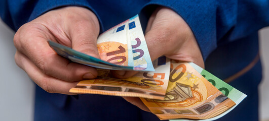 Female hands counting large amount EU euro money - obrazy, fototapety, plakaty
