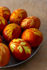 Easter eggs dyed with onion peel, dill and parsley. Natural eco dyes. Egg on the table top view food background. Spring homemade DIY craft concept.