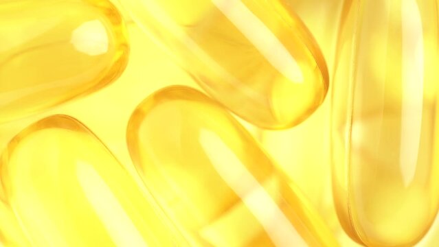 Food supplement oil filled. Capsules with omega 3 or vitamin A, E, fish oil. Macro shot, slow motion, top view. Pills background, capsules texture