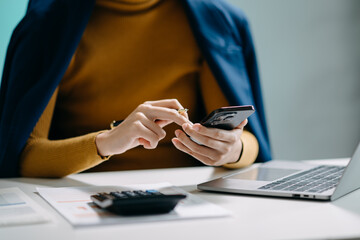 businesswoman working with digital tablet computer and smart phone with financial business strategy layer effect on desk