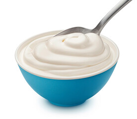 Bowl of sour cream with spoon isolated on white background, full depth of field