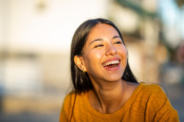 happy young woman laughing and looking away