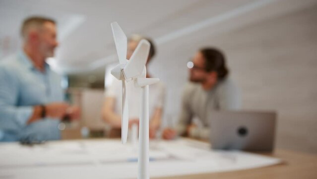 3D modeling for a wind energy project: Group of sustainable engineers working together on a windmill design