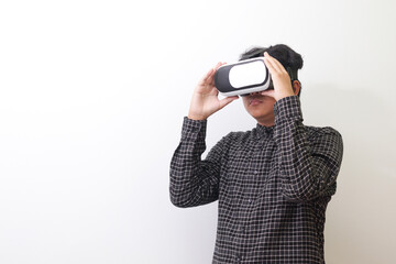 Portrait of Asian man in black plaid shirt using Virtual Reality (VR) glasses and looking up. Isolated image on white background