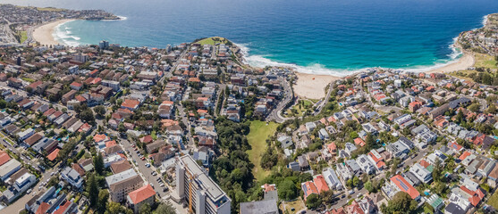 Panoramic aerial drone view of the beachside suburbs of Bronte, Tamarama and Bondi, looking in the east direction in Sydney, NSW Australia on a sunny morning  - obrazy, fototapety, plakaty