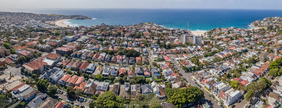 Panoramic aerial drone view of the beachside suburbs of Bronte, Tamarama and Bondi, looking in the east direction in Sydney, NSW Australia on a sunny morning 