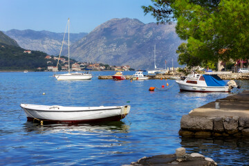 Fototapeta na wymiar Kotor, Montenegro boats and high mountains