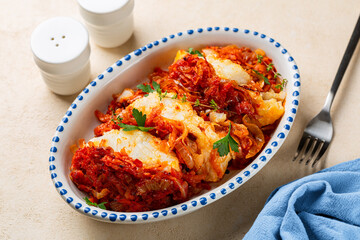 Served Greek and Polish style oven baked cod fish Psari Plaki with sauteed, shredded vegetables,...