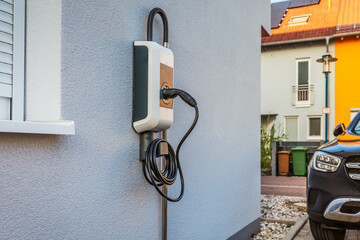 Wallbox on a family house wall for comfortable charging of electric car