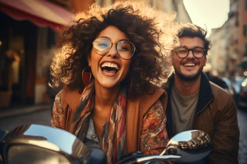 Fotobehang Young couple laugh riding motorbike in city. Happy student lifestyle job girl laughing driving cheerful smiling. Girlfriend and boyfriend travel on holidays. Love, romance fun on vacation concept © Valeriia