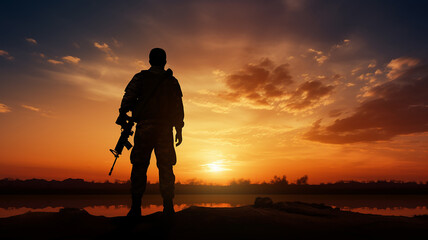 Soldier with a weapon silhouette against sunset - obrazy, fototapety, plakaty