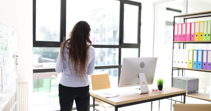 Inventory and young serious professional female auditor conducts inventory in company office. Manager writes notes