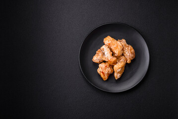 Delicious juicy grilled chicken pieces in sweet and sour sauce with salt and spices