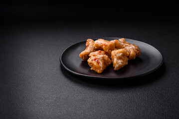 Delicious juicy grilled chicken pieces in sweet and sour sauce with salt and spices