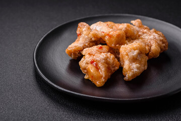 Delicious juicy grilled chicken pieces in sweet and sour sauce with salt and spices