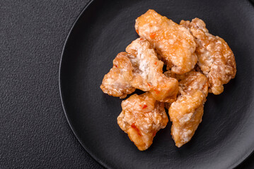 Delicious juicy grilled chicken pieces in sweet and sour sauce with salt and spices
