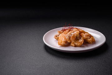 Delicious juicy grilled chicken pieces in sweet and sour sauce with salt and spices