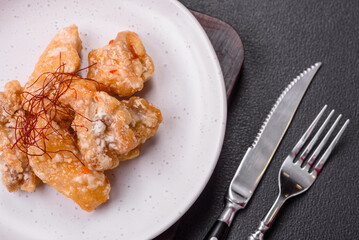 Delicious juicy grilled chicken pieces in sweet and sour sauce with salt and spices
