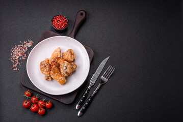 Delicious juicy grilled chicken pieces in sweet and sour sauce with salt and spices