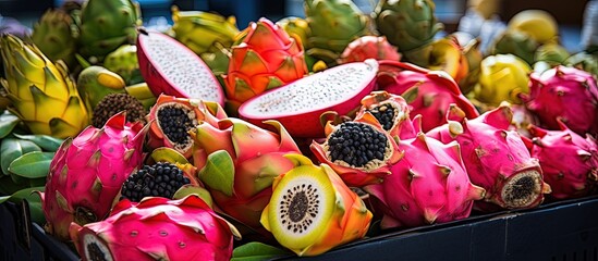 Various exotic fruits including delicious pitahaya dragon fruit displayed on a black market stall in Lanzarote Canary Islands with copyspace for text