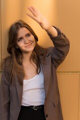 Portrait of a Caucasian attractive and happy young woman in casual clothes in the city while walking on a sunny day. The concept of style, fashion, youth and lifestyle