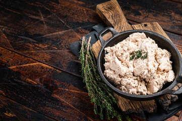 Cod liver Spread with oil in a skillet. Wooden background. Top view. Copy space