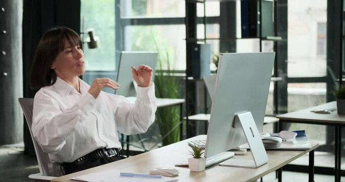 A displeased woman expresses frustration as she faces a setback while working at her office computer. Her emotions reflect the challenges and difficulties she is currently encountering in her work.