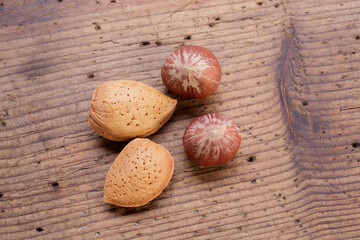 hazelnuts and almonds in shell on rustic wooden table shot from above
