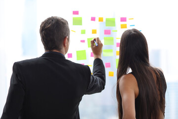 Collaborative process of professional businesspeople going over on new business together, using computer and clipboard presentation and brainstorming ideas, coworker and working together concept