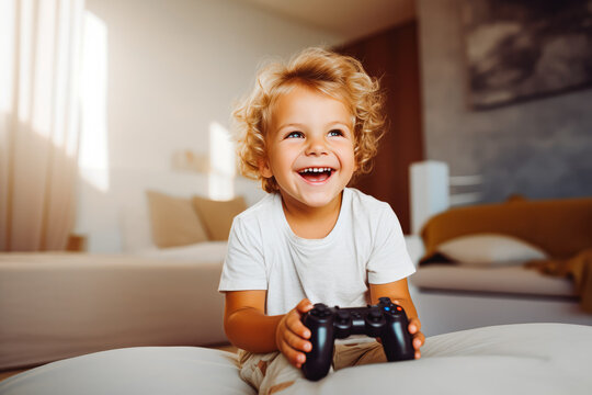 Image of beautiful smiling blond toddler playing with the game console in the living room and smiling, entertaining games for children
