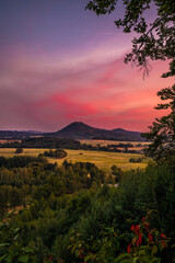 Romantic sunset view in northern Bohemia. Sky is full of colors and clouds fluffy and pink.