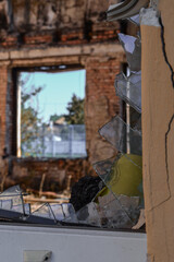 broken windows in a school that burned down during hostilities