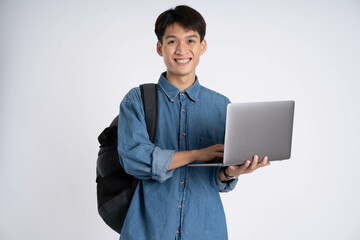 Portrait of Asian male student using laptop on white background