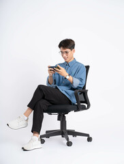 Full body of young Asian man using phone on white background