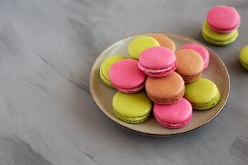 Colorful Homemade French Macarons on a Plate, side view. Copy space.