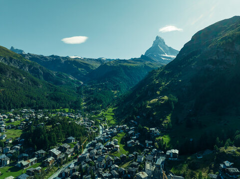 Aerial view of the Matterhorn, an iconic mountain peak with Zermatt town on foreground, Swiss Alps in summertime, Valais, Switzerland.
